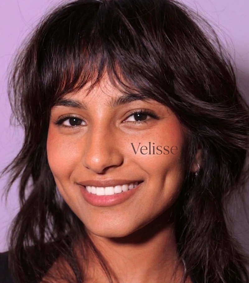Woman with shoulder-length hair and a blurred background